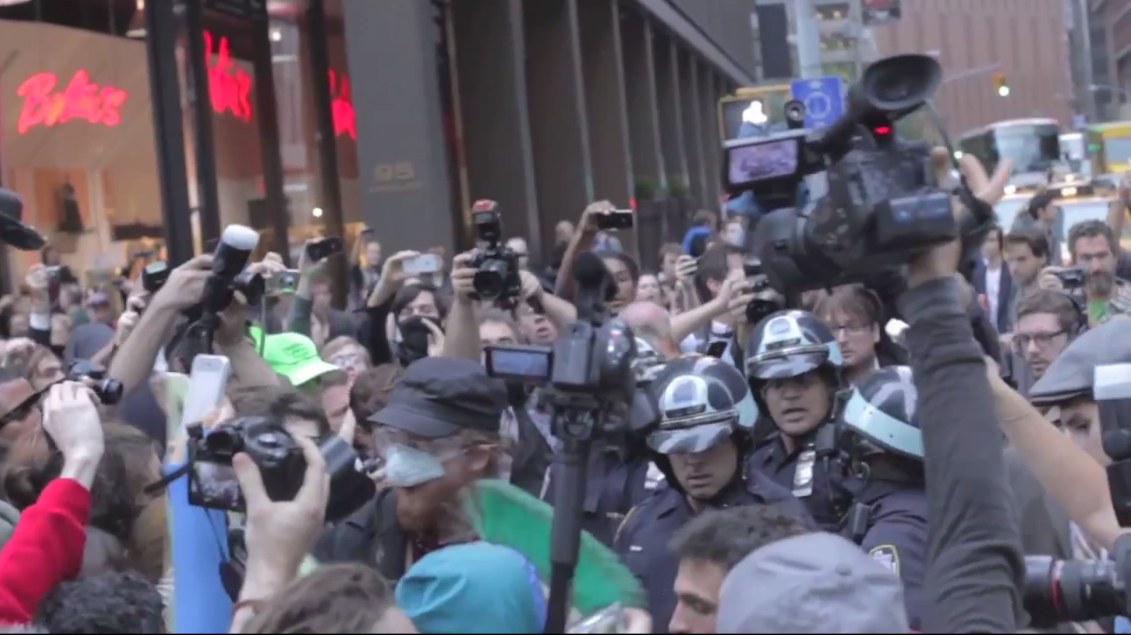 A sea of cameras. Screen capture of “Occupy Wall Street: The Whole World is Watching,” Archive.org,